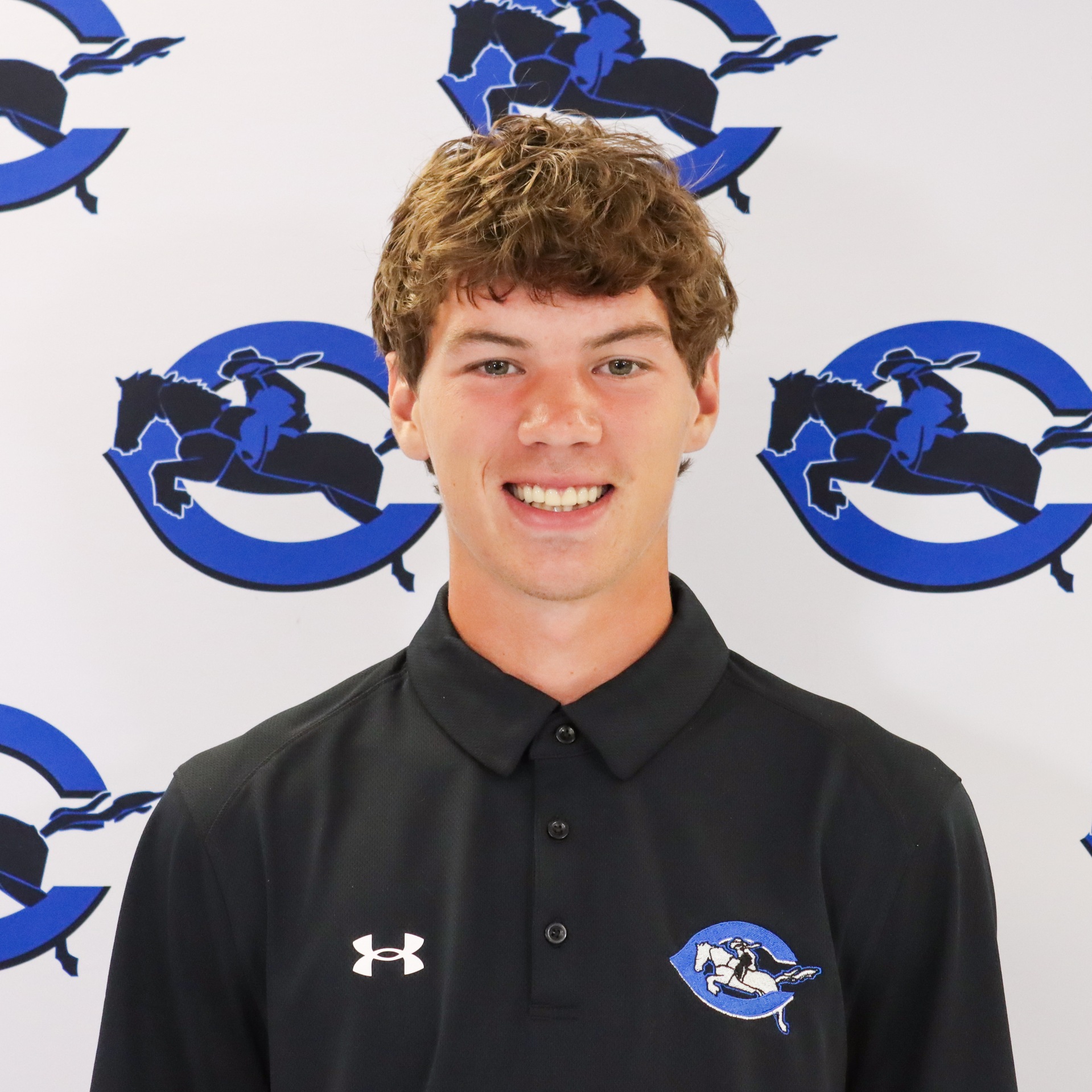 Hunter Gilliam photo in black shirt on Roughrider logo backdrop